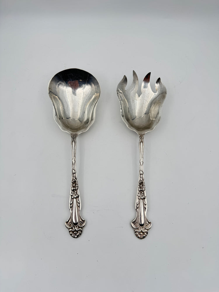 Pair of vintage sterling silver serving spoons with ornate floral handles. One solid and one slotted. For elegant dining or collecting.