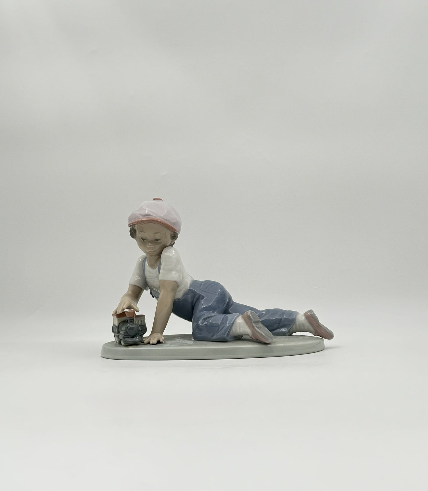 Lladró “All Aboard” #7619 Boy with Train Figurine