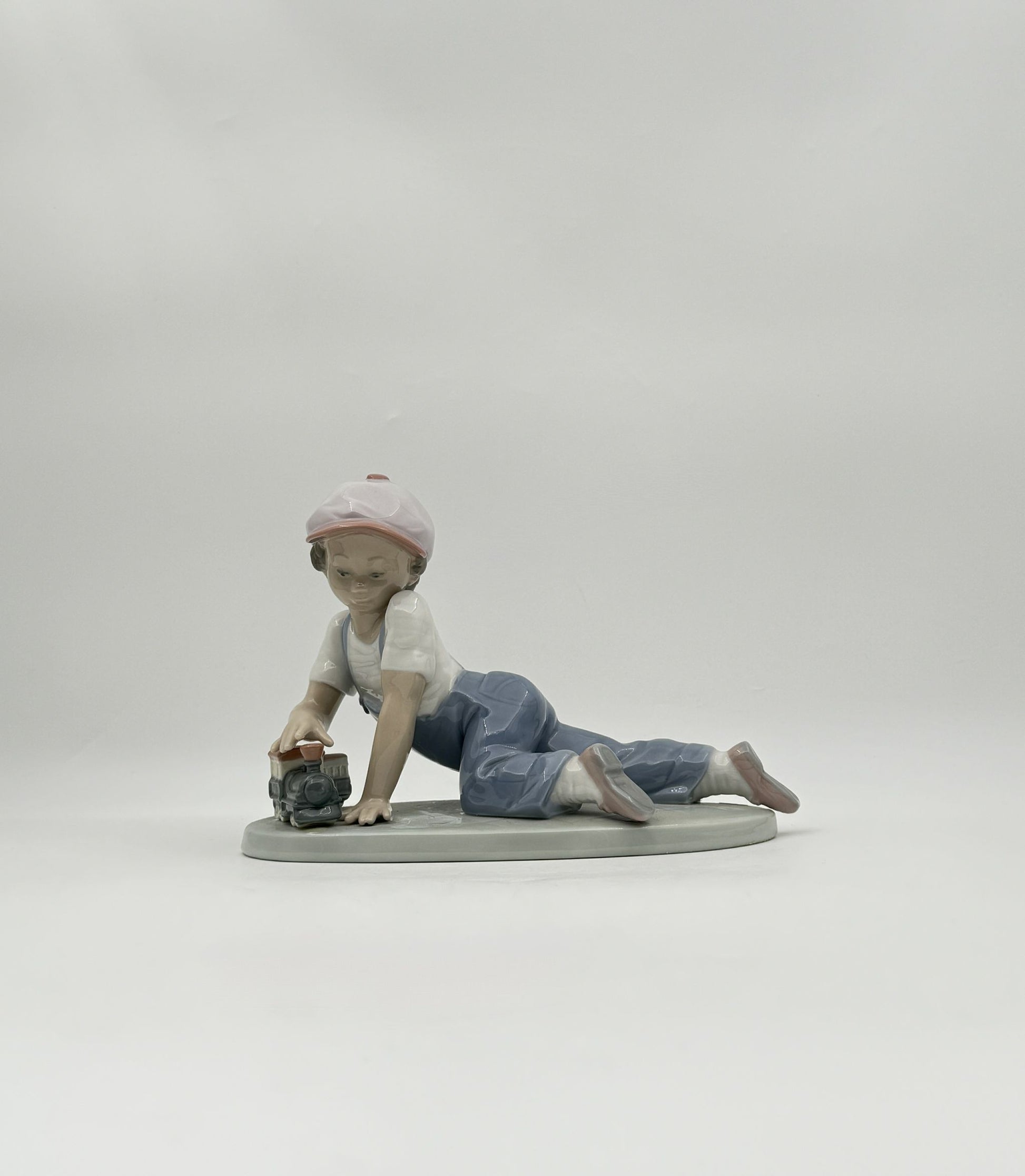 Lladró “All Aboard” #7619 Boy with Train Figurine