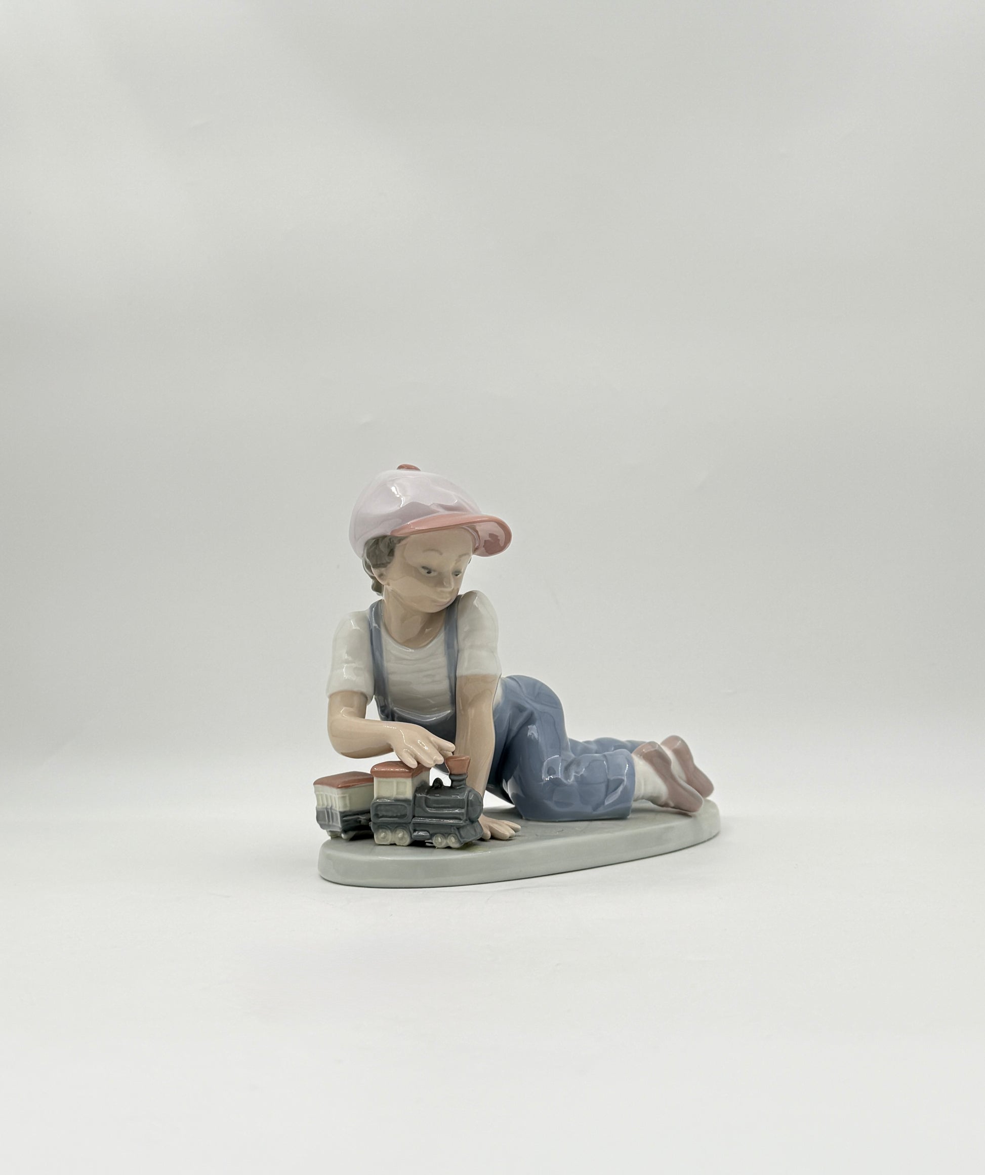 Lladró “All Aboard” #7619 Boy with Train Figurine