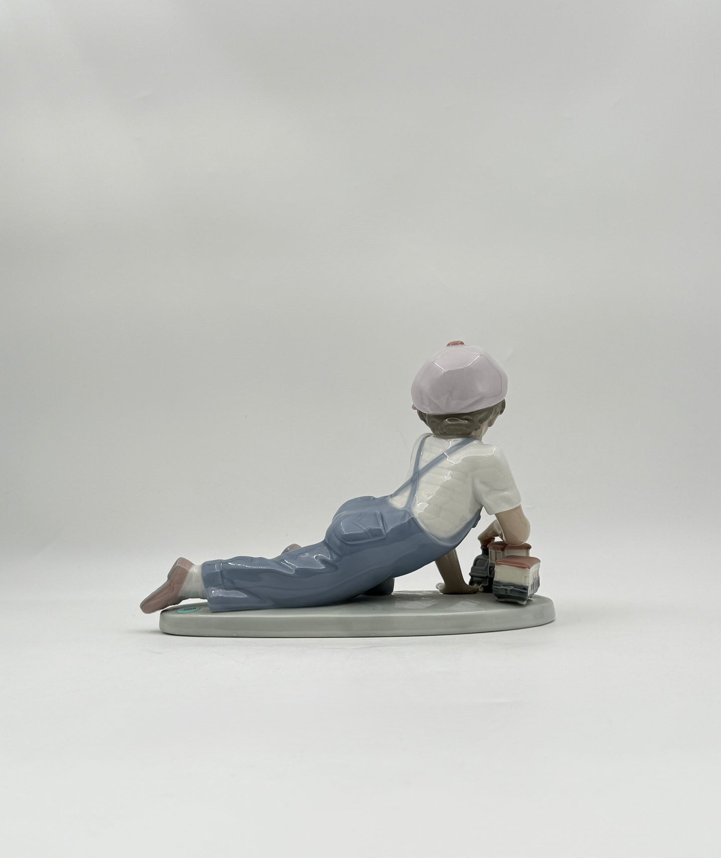 Lladró “All Aboard” #7619 Boy with Train Figurine