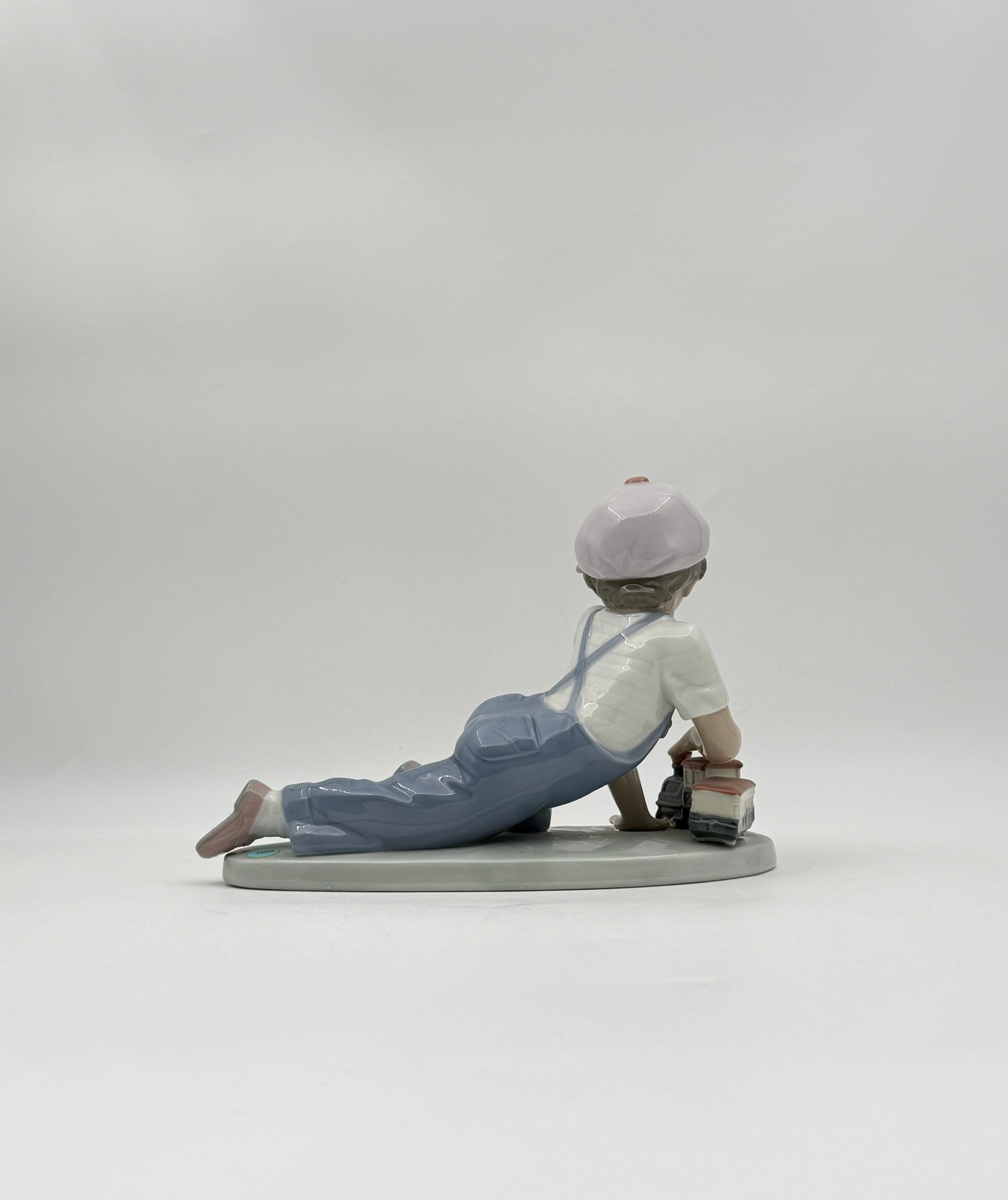 Lladró “All Aboard” #7619 Boy with Train Figurine