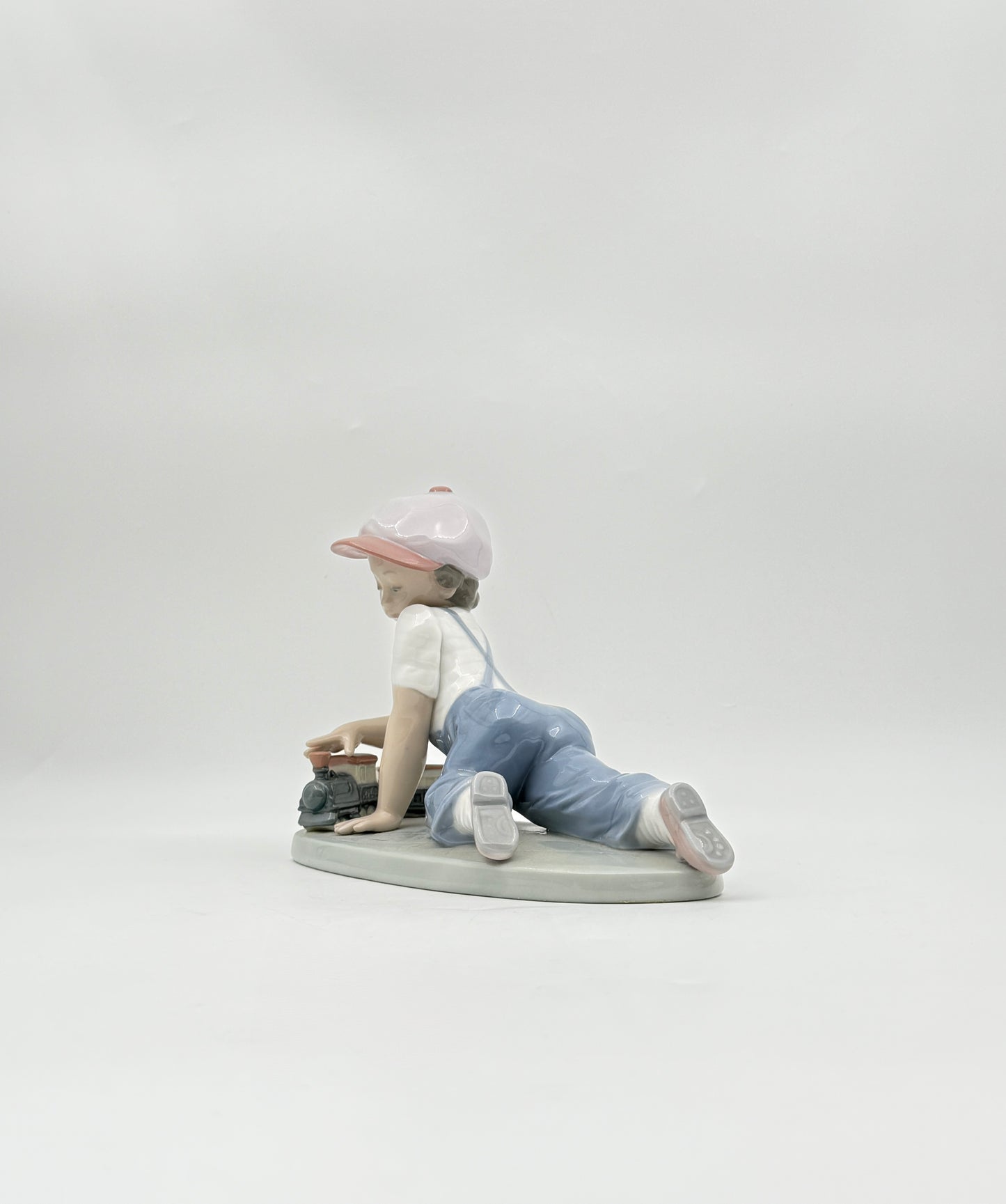 Lladró “All Aboard” #7619 Boy with Train Figurine