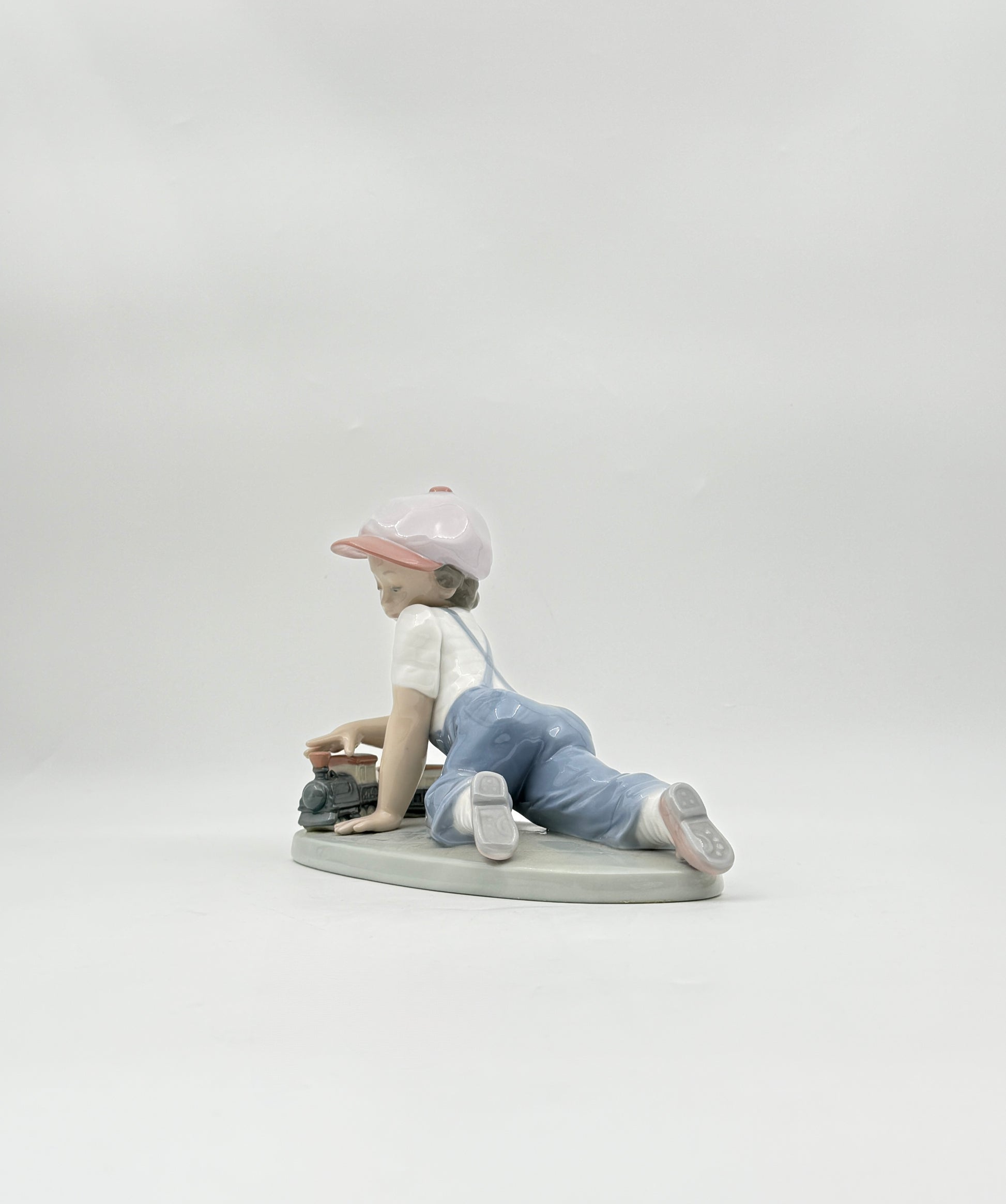 Lladró “All Aboard” #7619 Boy with Train Figurine